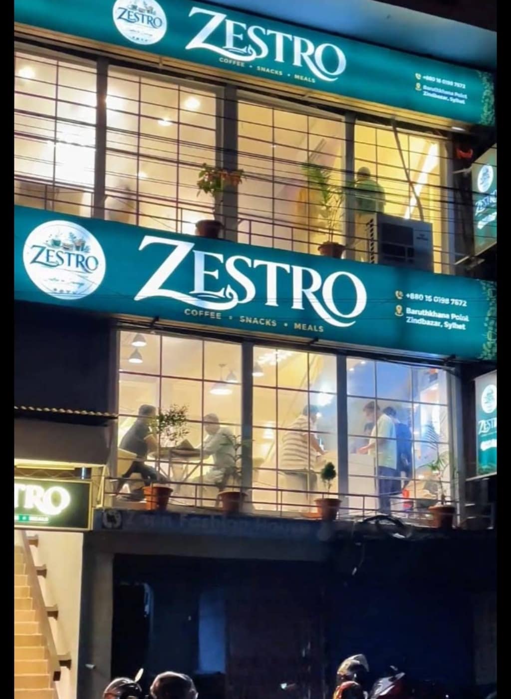 Zestro cafe storefront lit up at night on Barutkhana Road, Sylhet